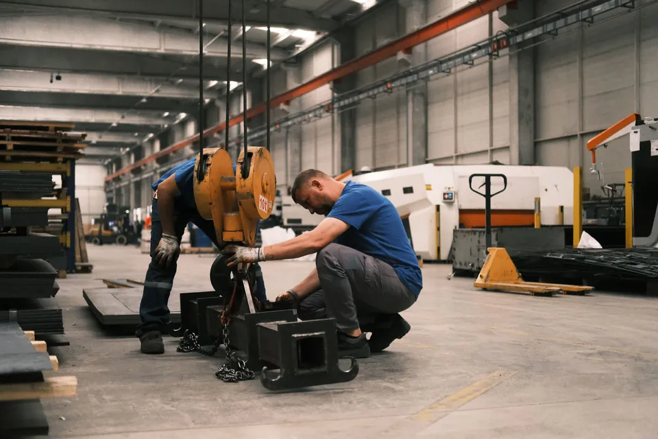 Deux techniciens assemblent une pièce dans un atelier de production